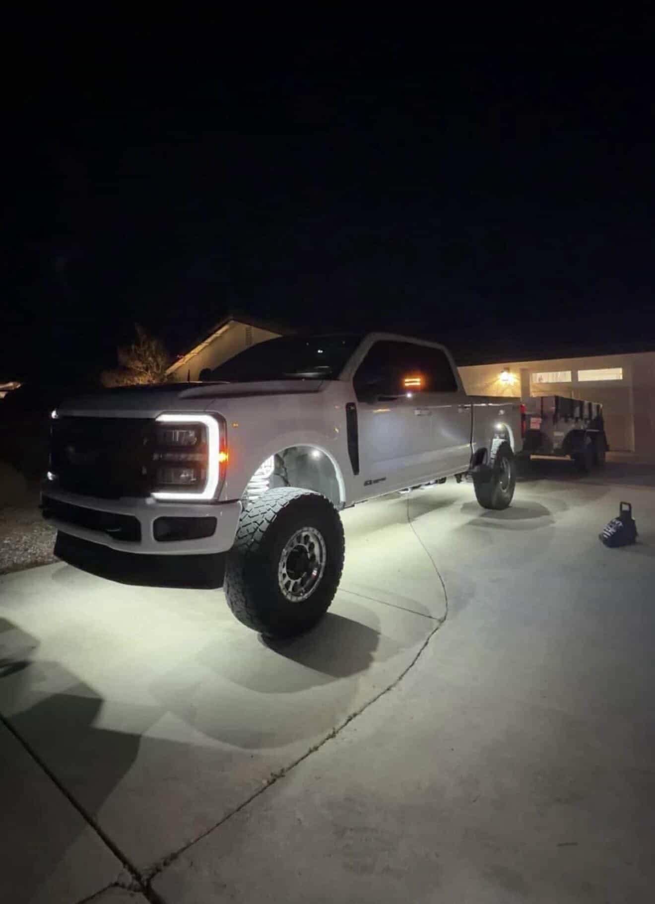 White Ford Super Duty with bright LED rock lights